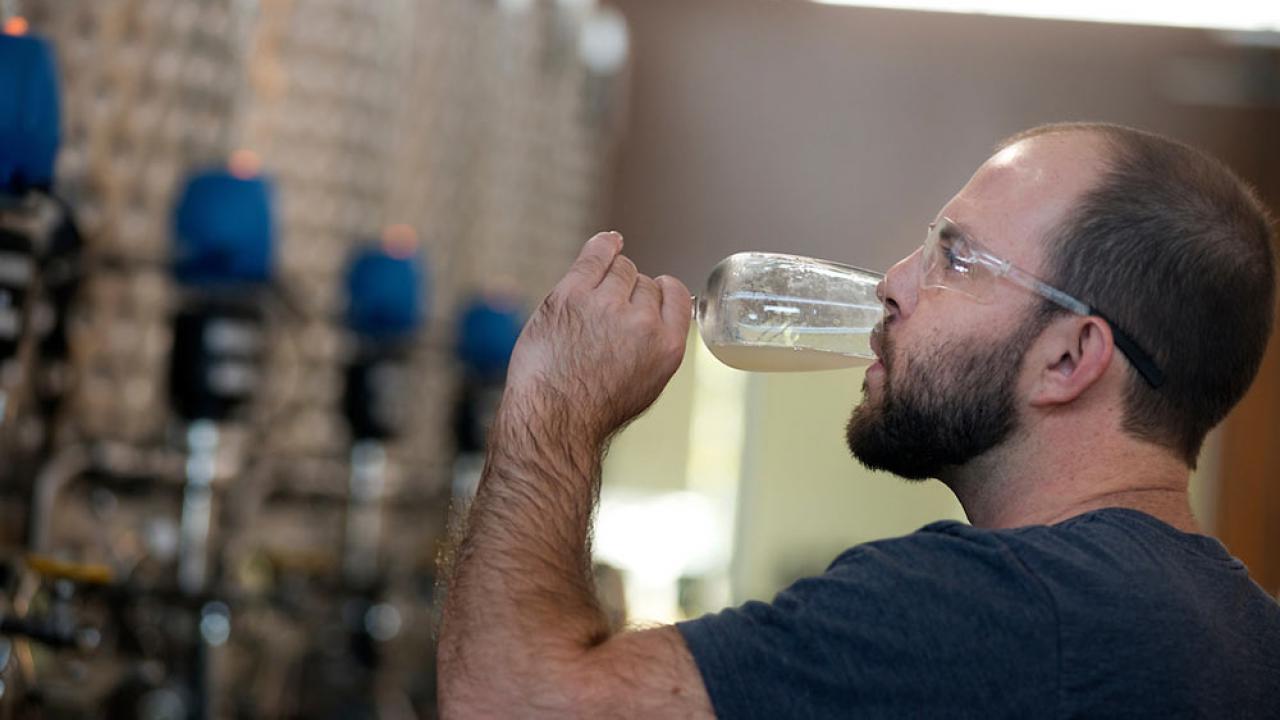 A UC Davis student sips his own ale creation in beer making class