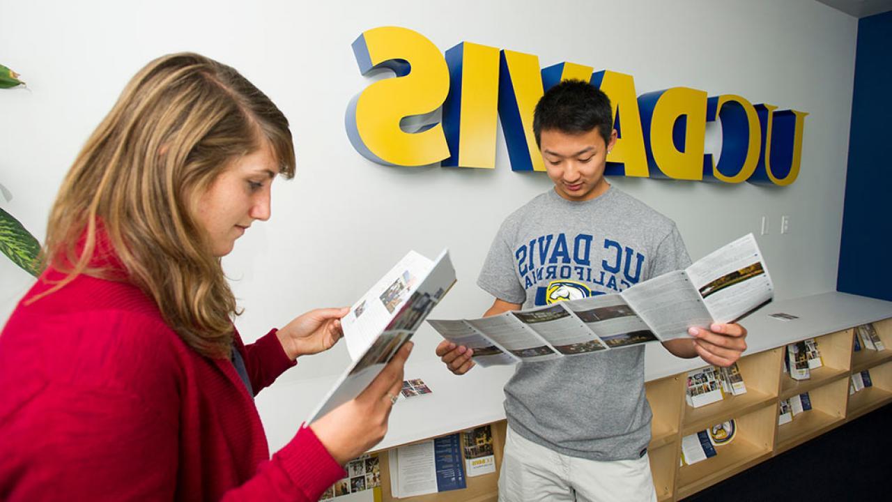 Students read brochures at the UC Davis Welcome center