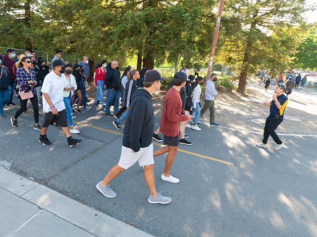 A student leading a group on a tour of campus