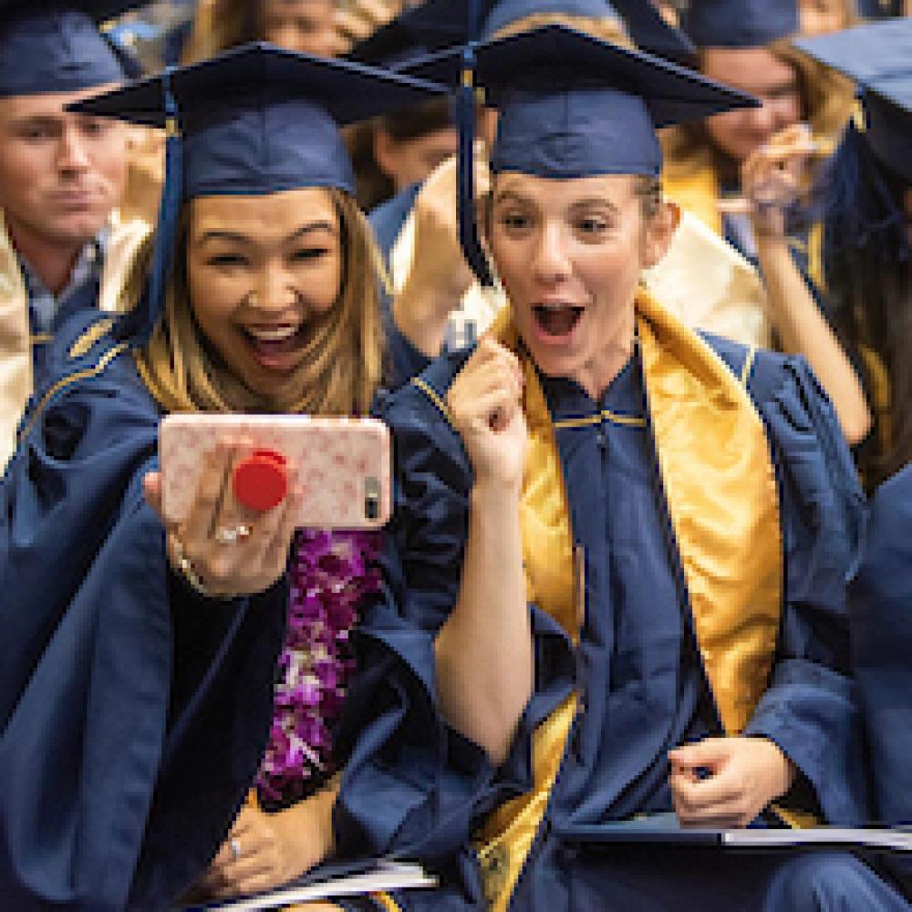 Students cheer graduation at UC Davis. 