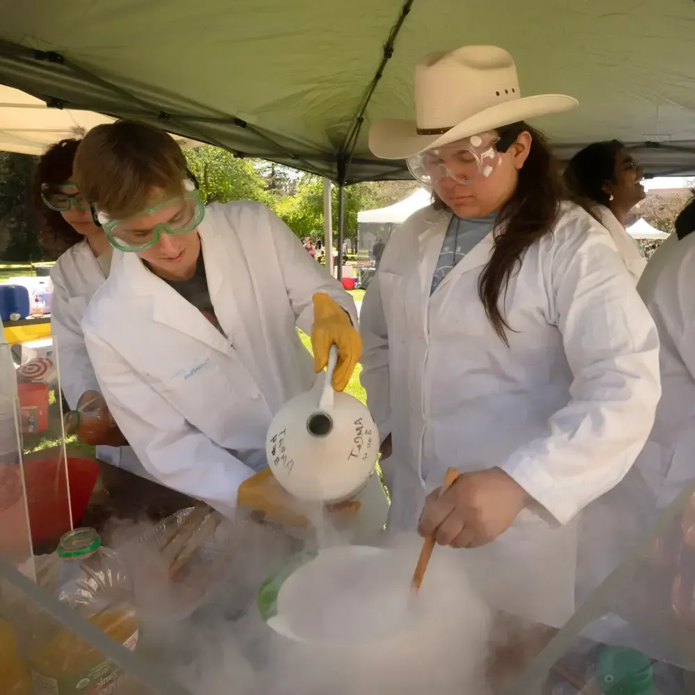 Students work to make liquid nitrogen sorbet and have to work through the fog of the nitrogen as it boils away during Picnic Day