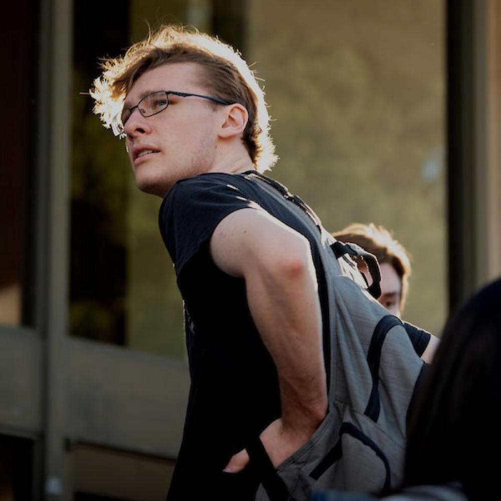 A male student looks back over his shoulder
